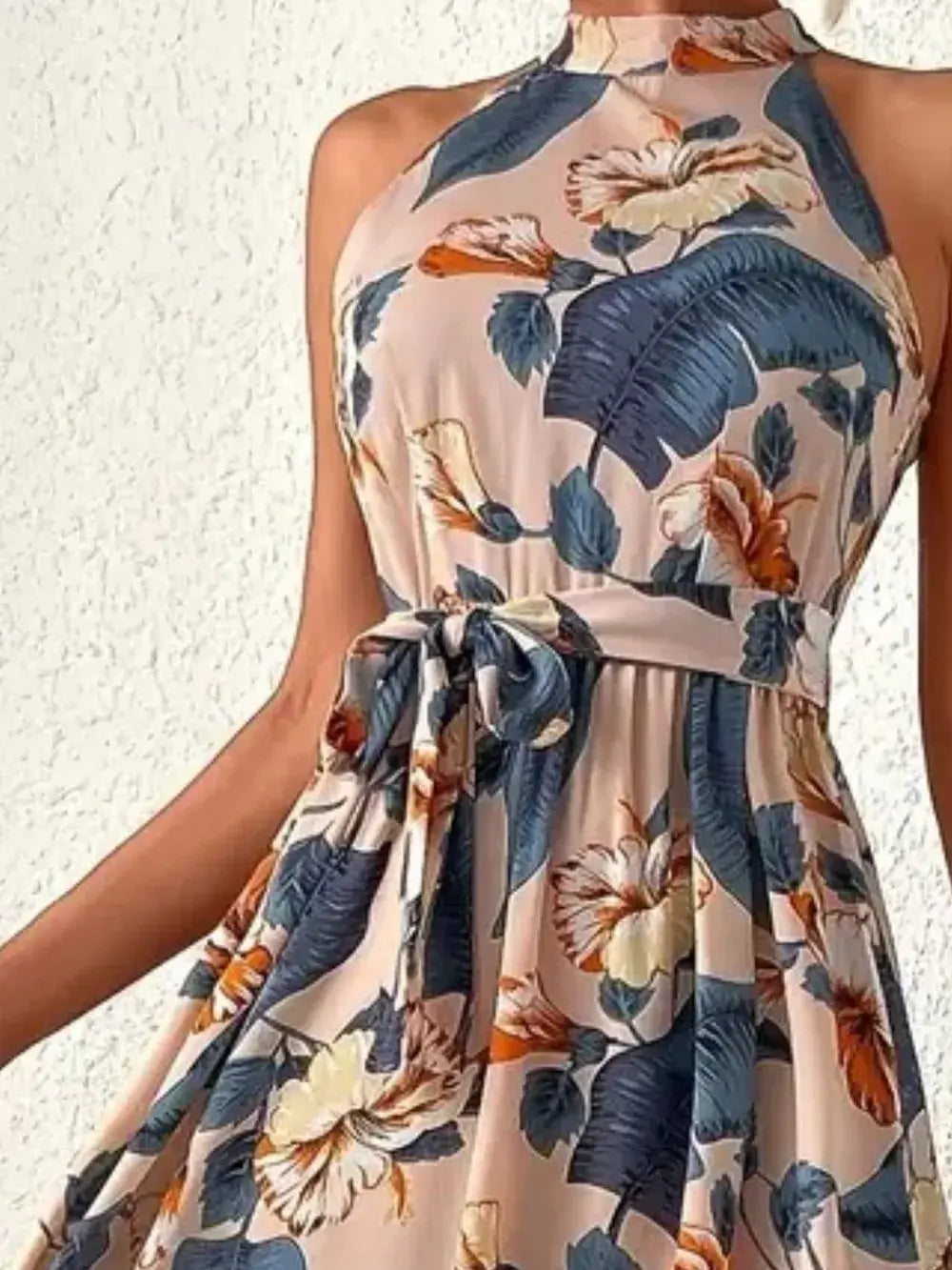 Tied Floral Sleeveless Dress in a floral pattern featuring a tie detail, perfect for summer outings.