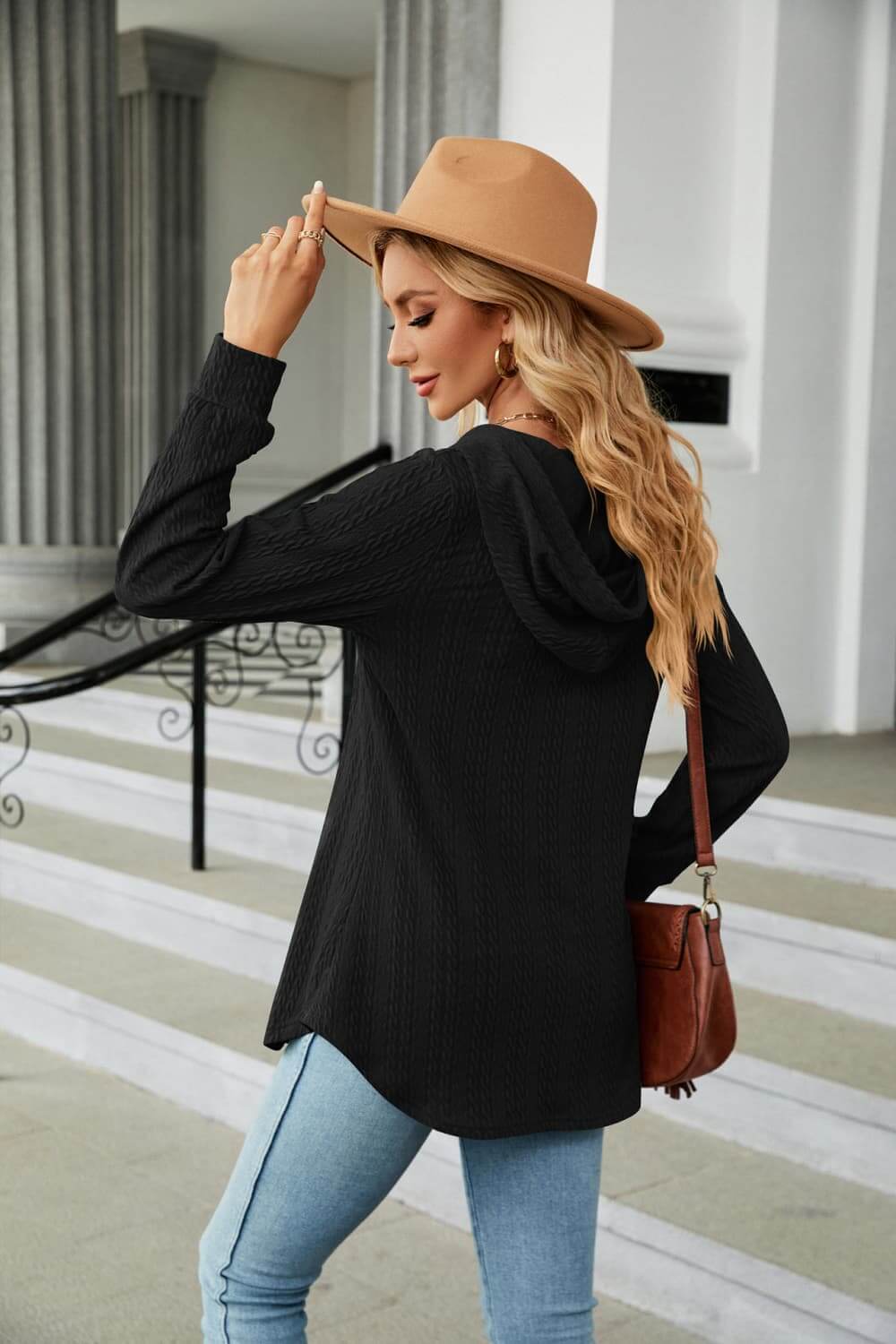 Woman wearing a Long Sleeve Hooded Blouse with hat, showcasing its casual style from the back.