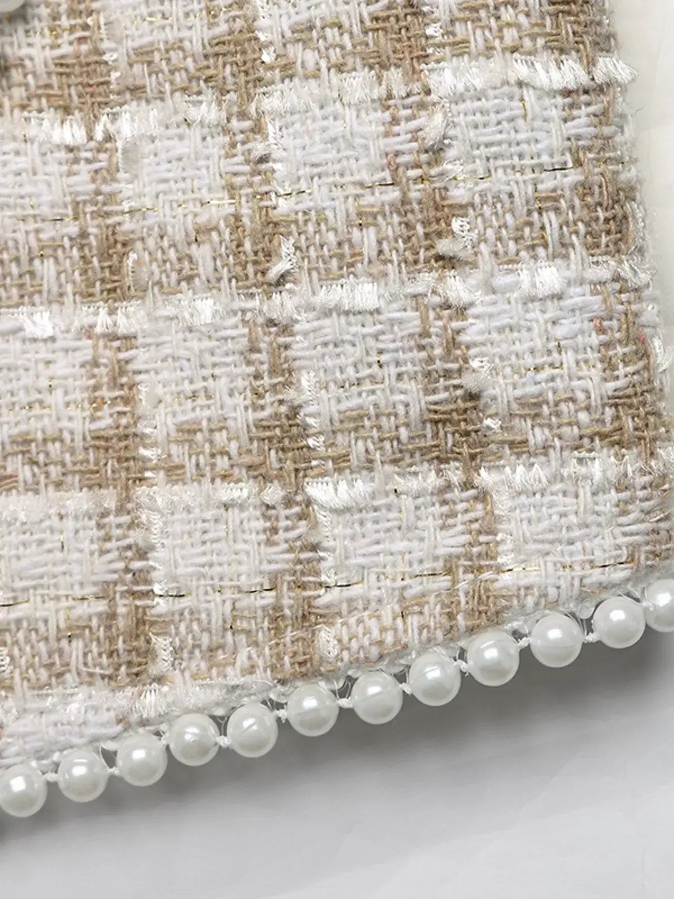 Close-up of the fabric texture showcasing plaid design and pearl detailing on the Plaid Button-Front Long Sleeve Outerwear.