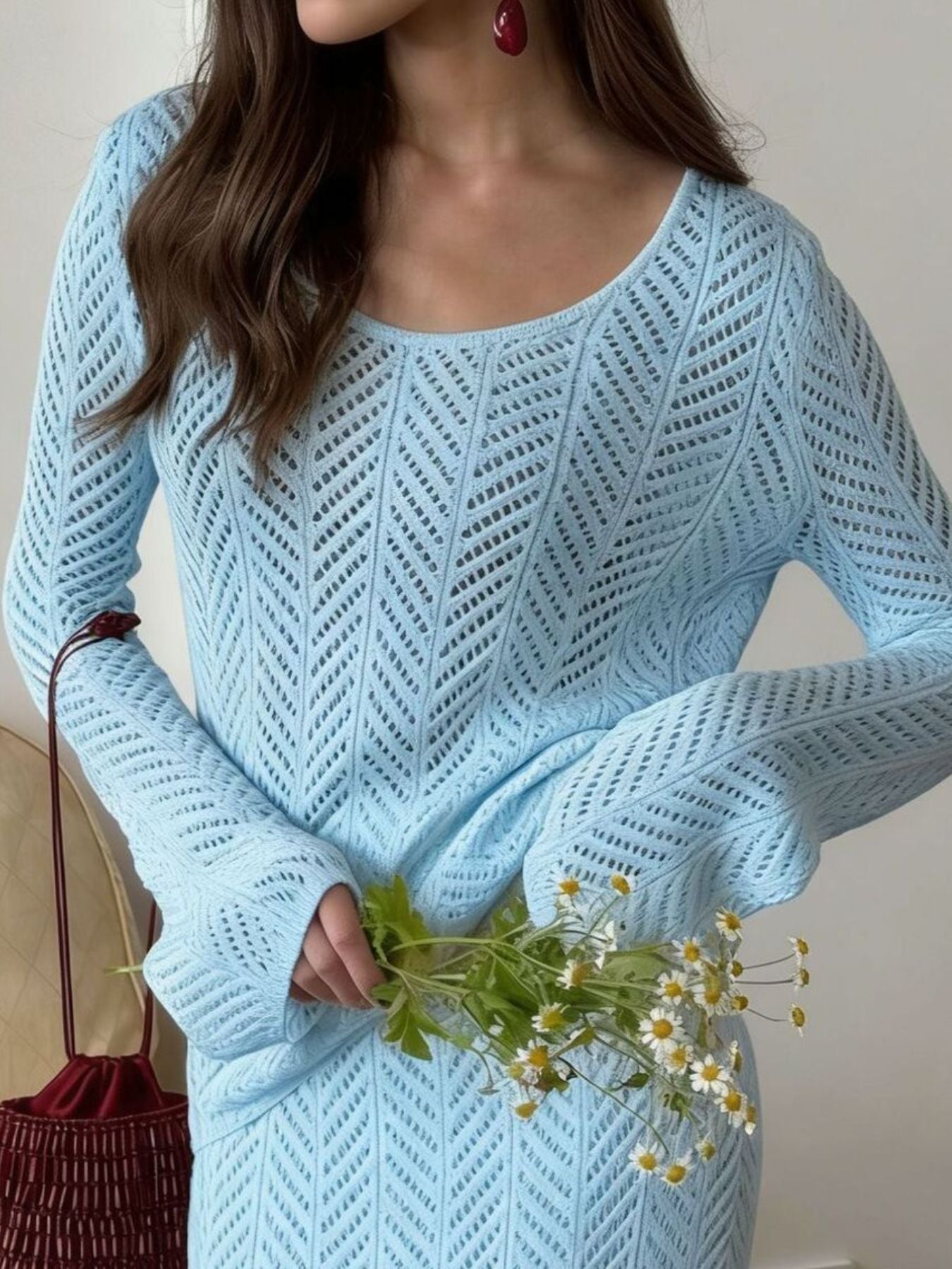 Openwork Long Sleeve Knit Top and Skirt Set worn by woman holding flowers in light blue color.