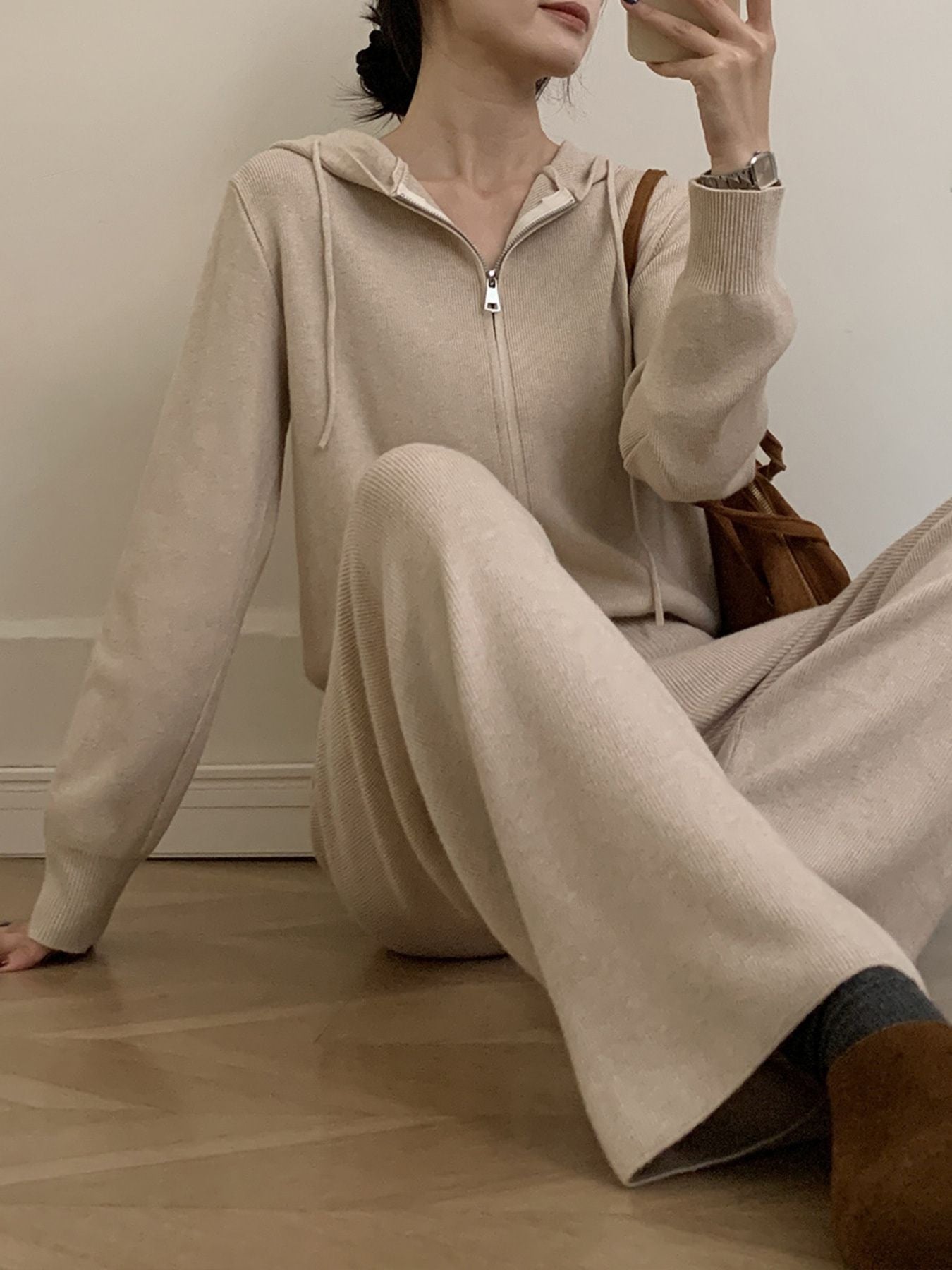 Woman wearing a Zip Up Cardigan and Wide Leg Pants Knit Set in beige, showcasing the two-piece outfit with a zipper and drawstring features.