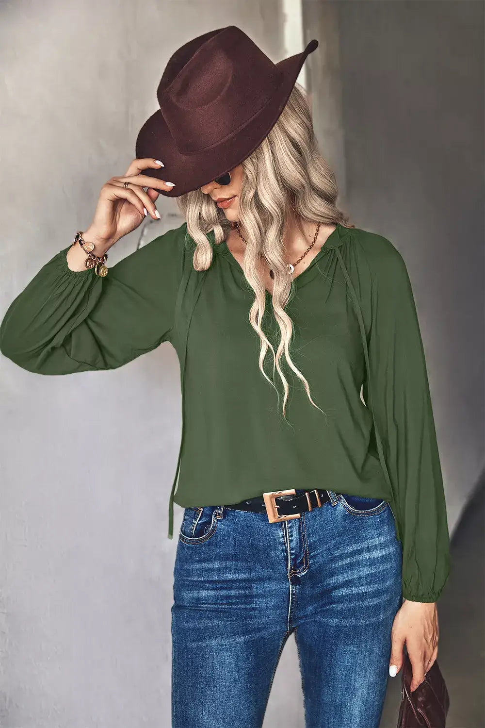 Tie Neck Long Sleeve Blouse in green, stylish women's office wear paired with jeans and a brown hat.