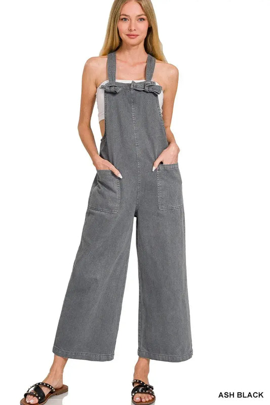 Zenana Washed Knot Strap Pockets Jumpsuit in ash black color on model with adjustable knot straps and side pockets.