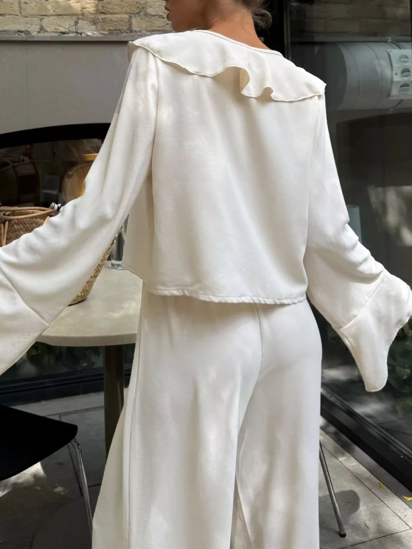 Ruffle Trim Tie Front Top and Pants Set for Women in white, showcasing ruffled collar and bell sleeves from the back.