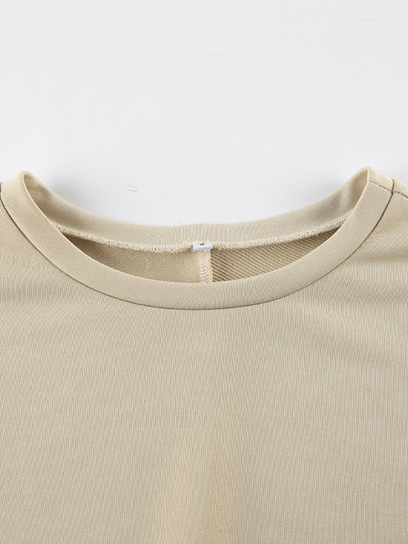 Close-up of the neckline of the Round Neck Top and Wide Leg Pants Set in beige color.