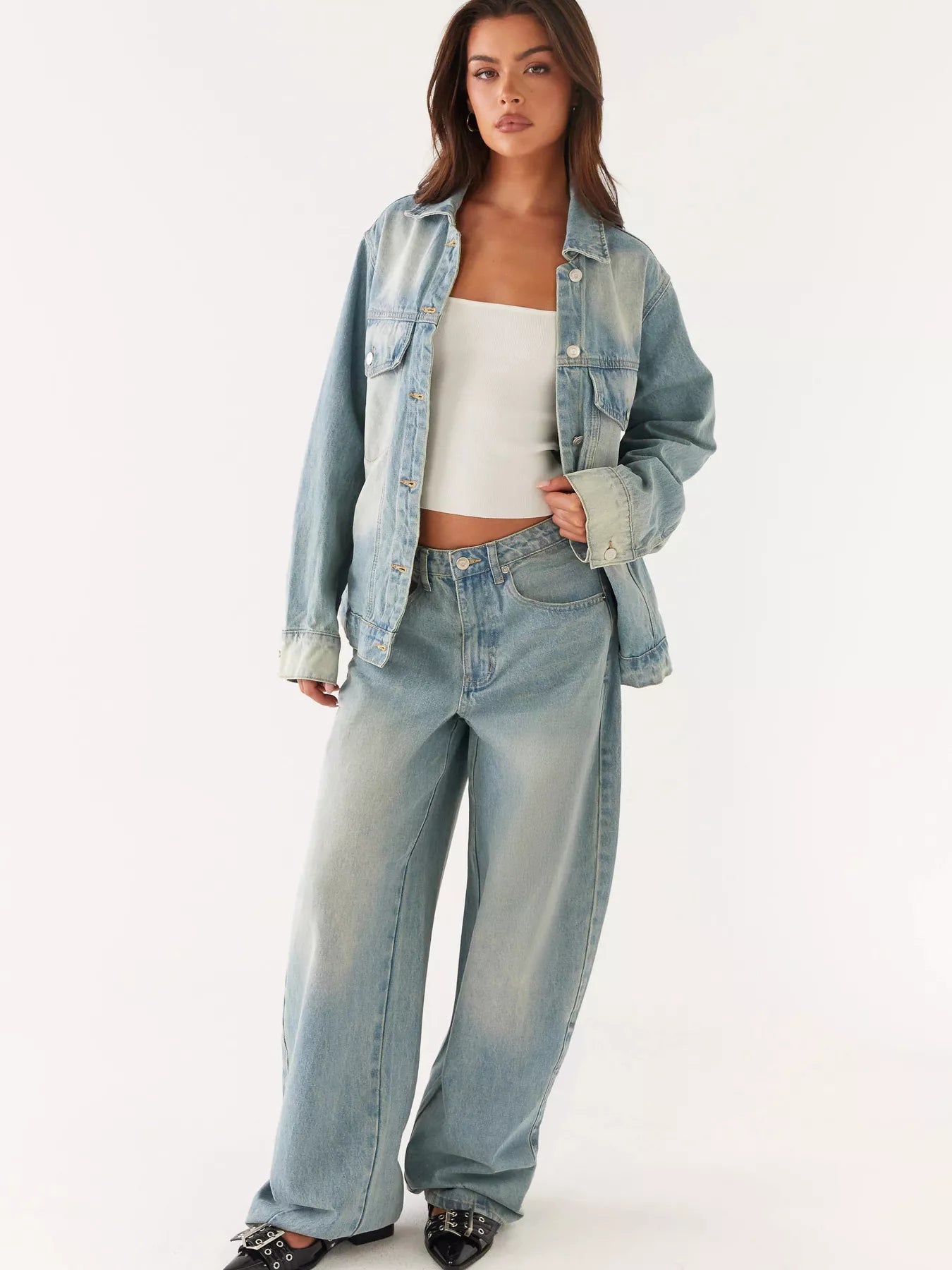 Model showcasing Button Up Denim Jacket and Jeans Set featuring a relaxed fit and light blue denim.