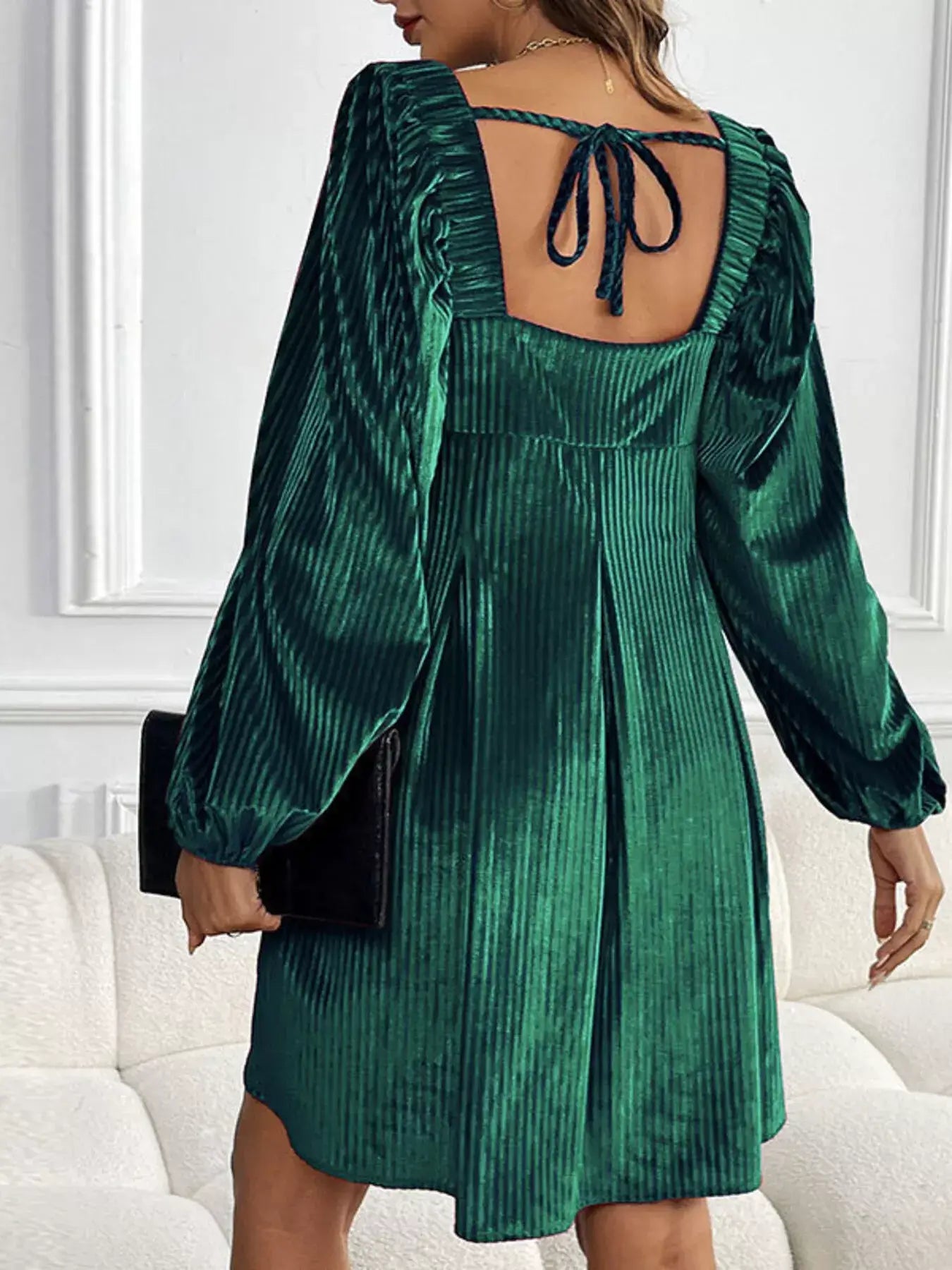 Back view of a model wearing a Velvet Square Neck Long Sleeve Dress in deep green with stylish puff sleeves.