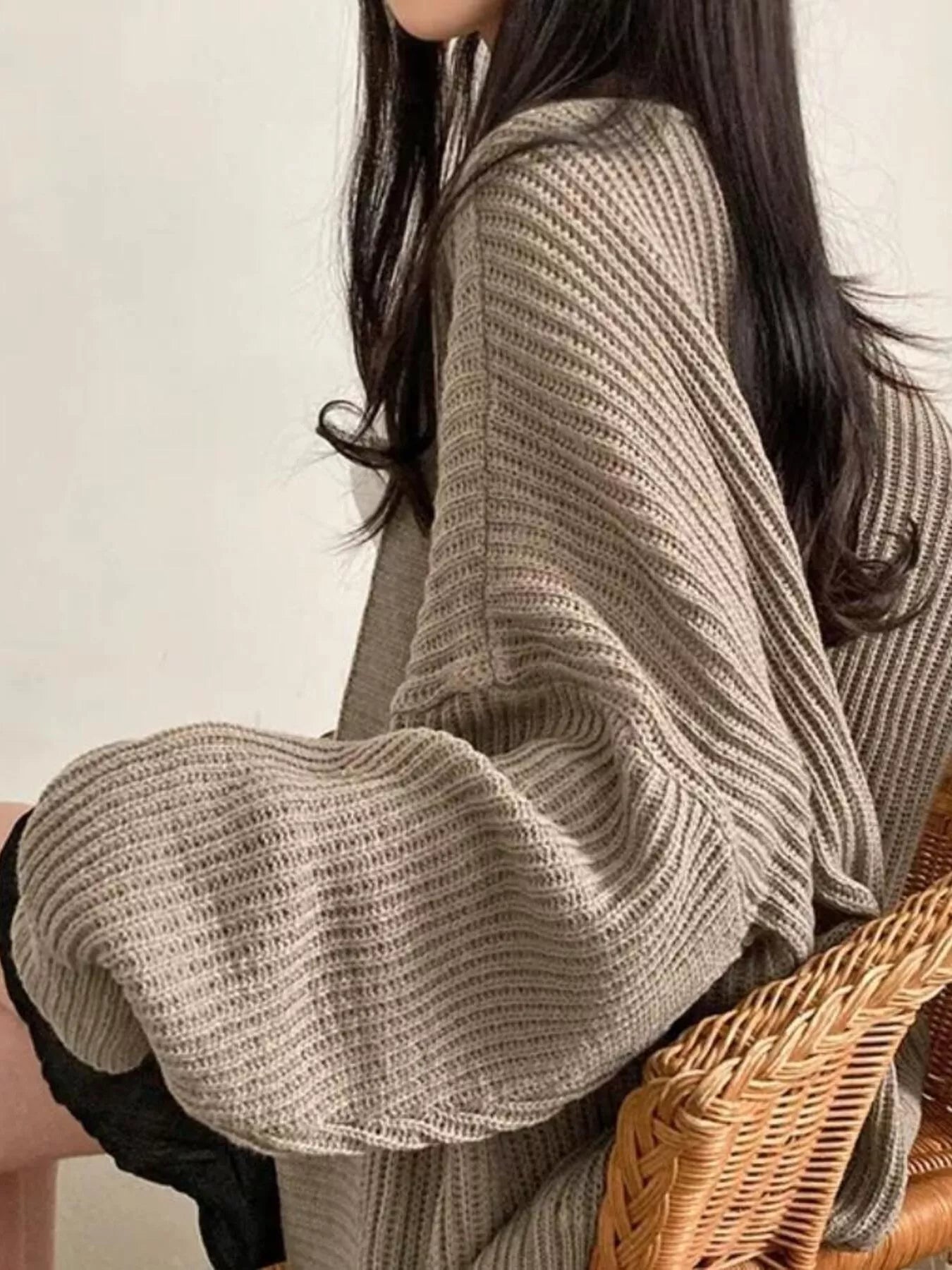 Open Front Oversized Knit Cardigan for Women shown in a cozy setting with stylish, flowing sleeves.