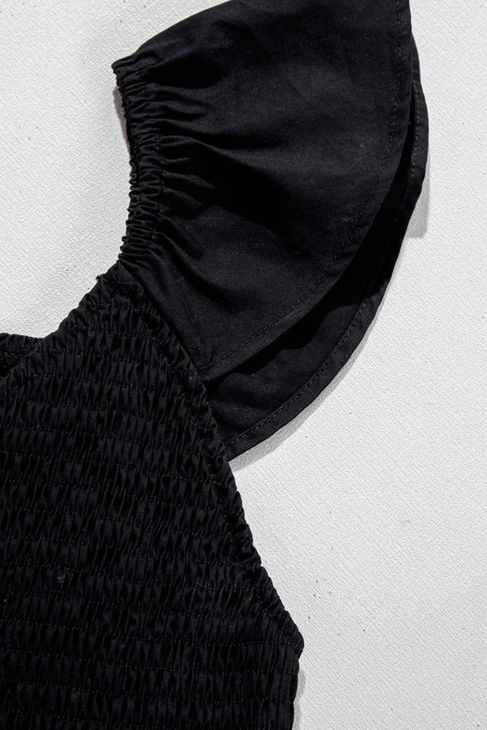 Close-up of V Neck Ruffled Cap Sleeve Smocked Maxi Dress featuring ruffled cap sleeves and smocked body detail.