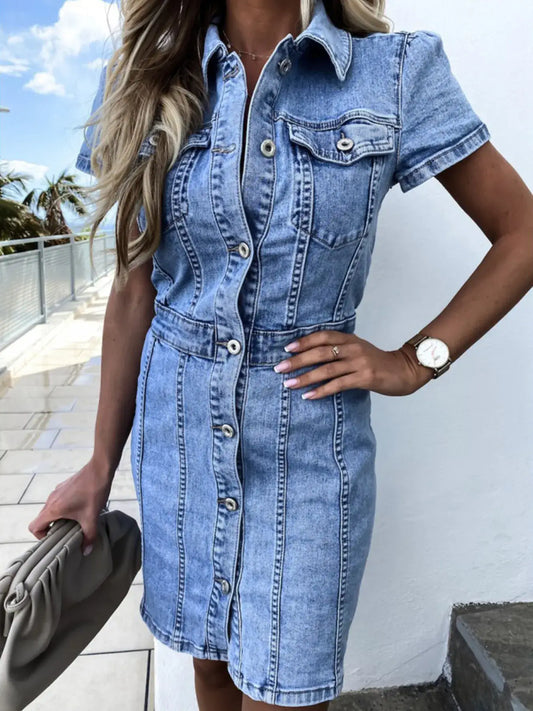 Woman in a short sleeve button front denim dress paired with a stylish handbag, perfect for casual outings.