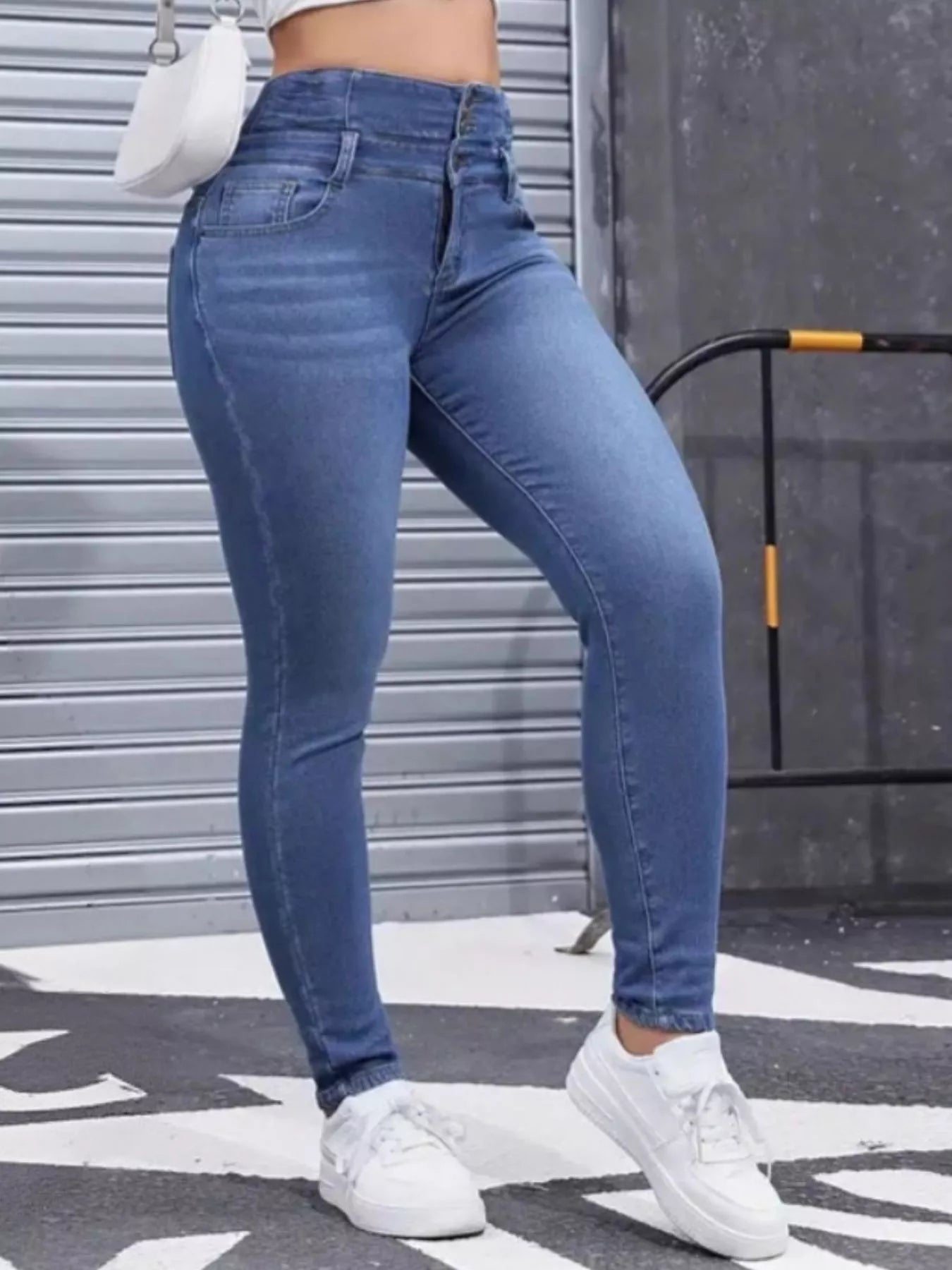 High-Waisted Slim Fit Fleece-Lined Jeans styled with a fitted top and white sneakers on a street background.