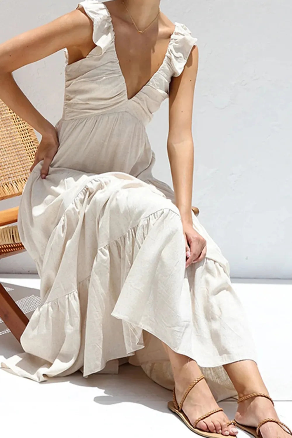 Ruffled V-Neck Tiered Dress shown in a light color with ruffled straps and a flowing tiered skirt.