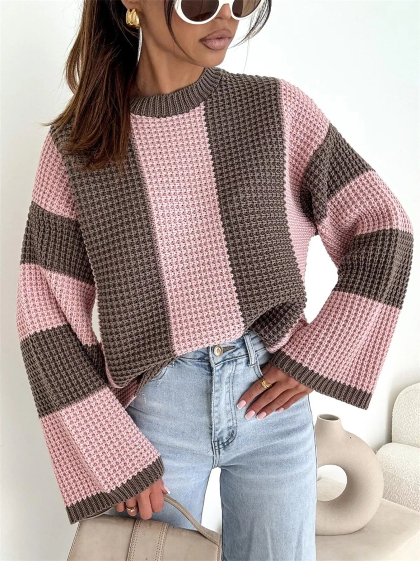 Color Block Long Sleeve Sweater in pink and brown oversized knit style, featured with wide sleeves and paired with jeans.