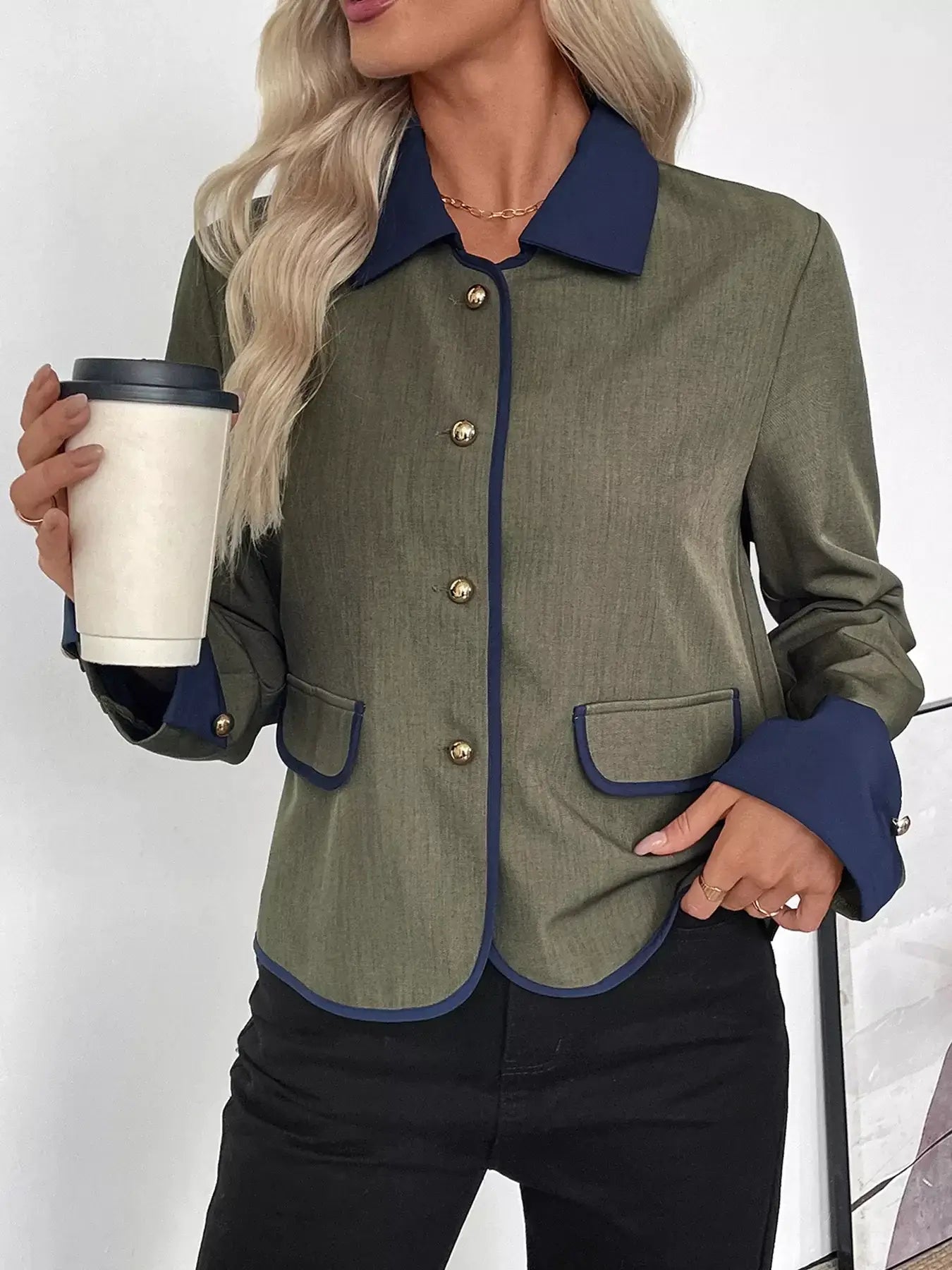 Woman wearing a Contrast Trim Button-Up Jacket, holding a coffee cup, showcasing modern elegance and tailored fit.