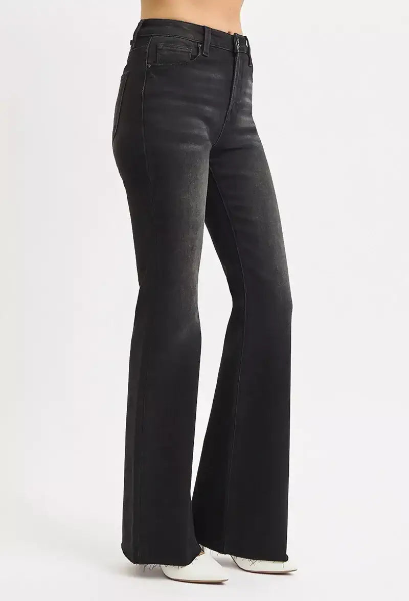 RISEN Full Size High Rise Flare Raw Cut Hem Jeans in black, showcasing a flattering silhouette and trendy 70s style.