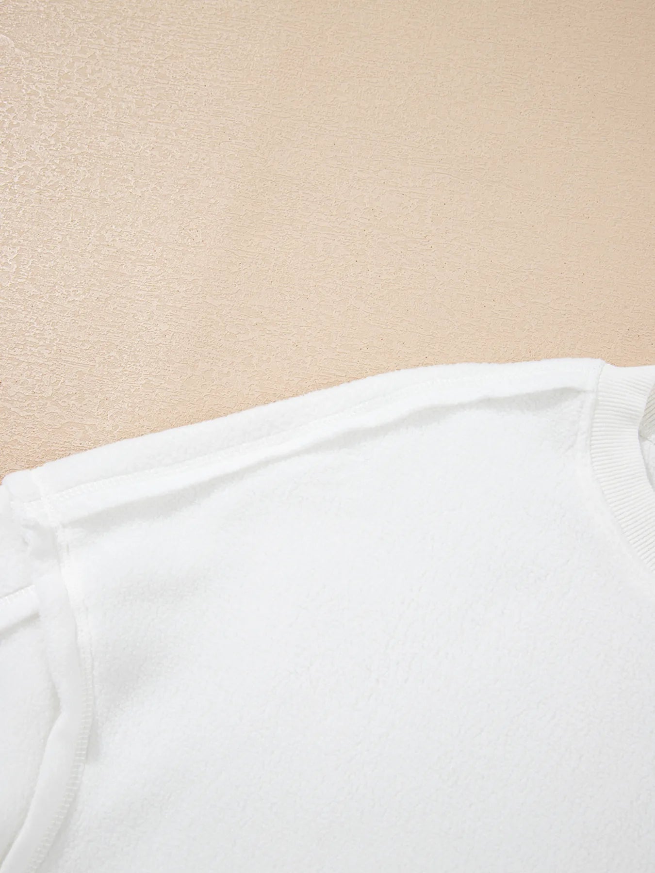 Exposed Seam Chest Pocket Knit Pullover Sweatshirt showing shoulder and seam details on soft fabric.