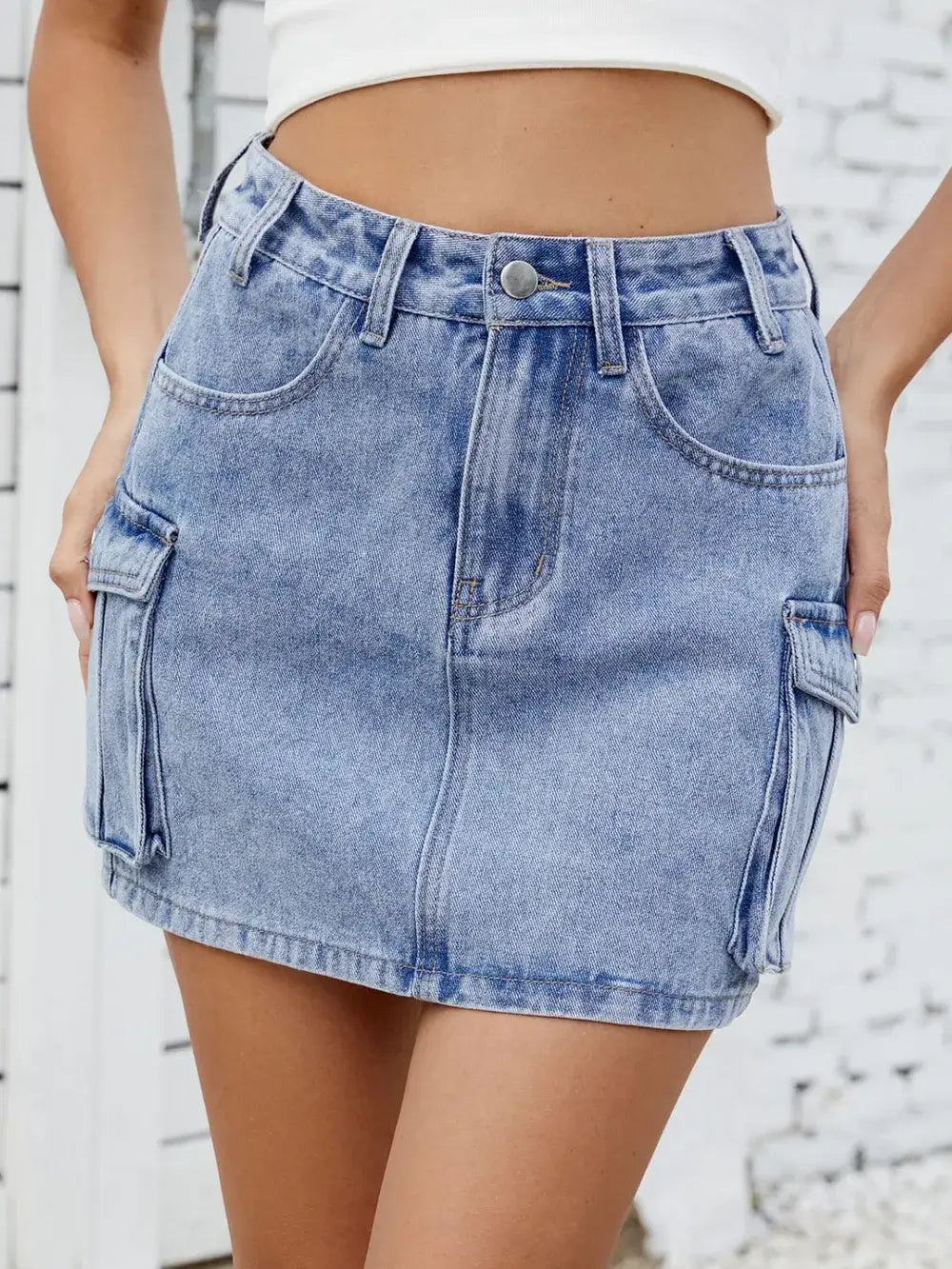 Cargo denim skirt for women with functional pockets in light blue, perfect for casual wear and trendy street style.
