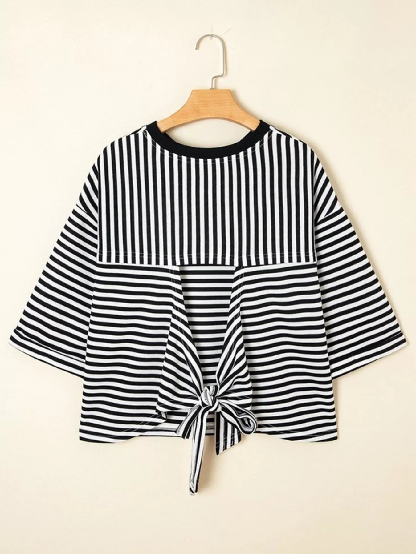 Striped Back Bow Tie T-Shirt showcasing a stylish oversized design with a bow tie detail and black and white stripes.