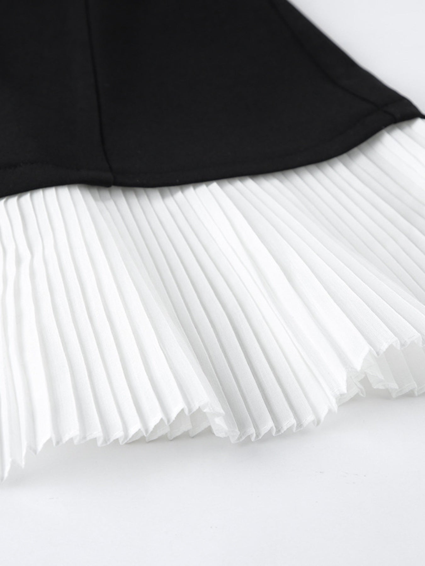 Pleated One Button Blazer Dress showcasing elegant black and white pleated hem detail.