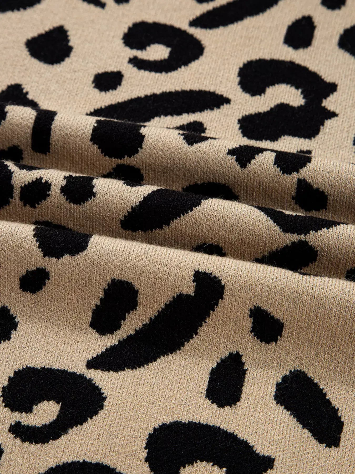 Close-up of leopard pattern fabric showcasing sophisticated design for Leopard Pattern Lace Ribbed Detail Button Top.