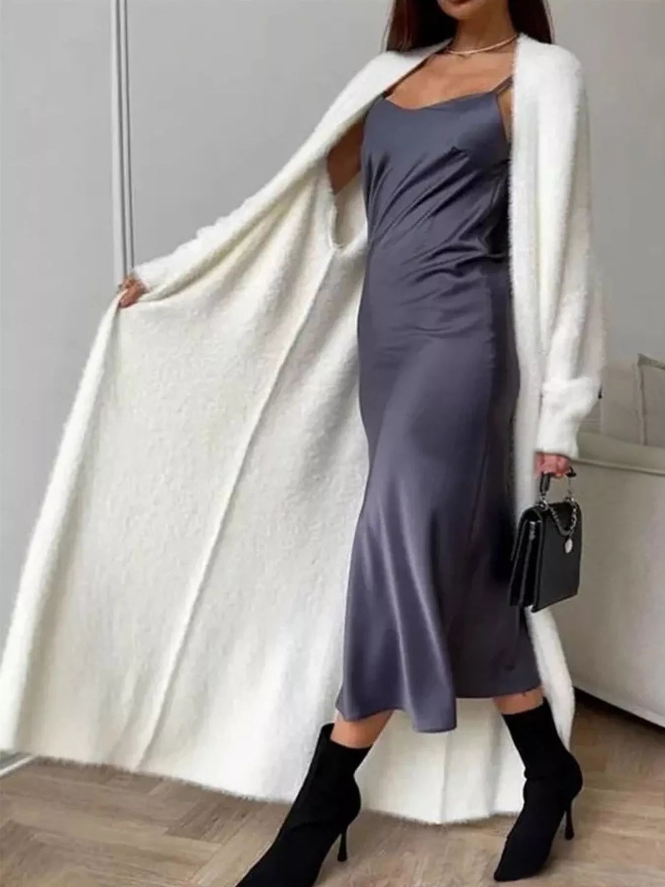 Model wearing a Fuzzy Open Front Longline Cardigan over a satin dress, showcasing cozy layering style