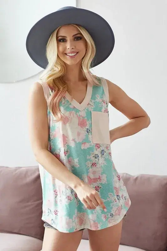 BiBi Multi Color Flower Printed Tank with Contrast Band worn by a smiling model in a wide-brimmed hat.