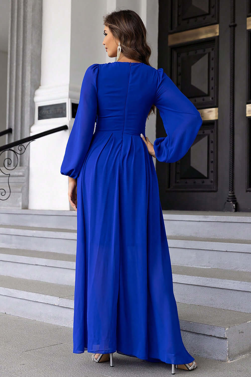 Back view of Twist Front Cutout Long Sleeve Dress in elegant blue, showcasing long sleeves and a flowing silhouette.