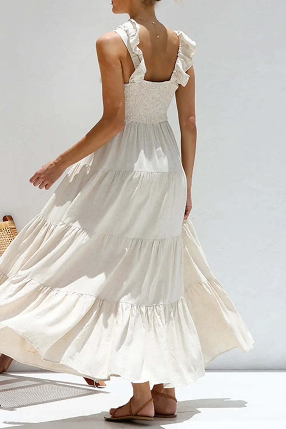 Ruffled V-Neck Tiered Dress showcased from the back, featuring elegant smocked design and tiered layers in white cotton.
