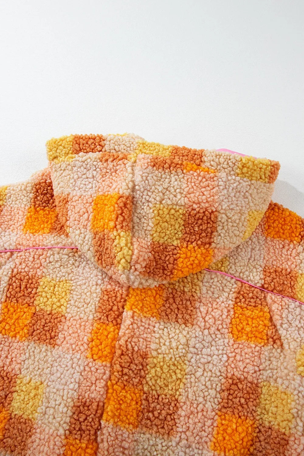 Checkered Long Sleeve Sherpa Hooded Jacket seen from the back with a colorful orange and yellow pattern.