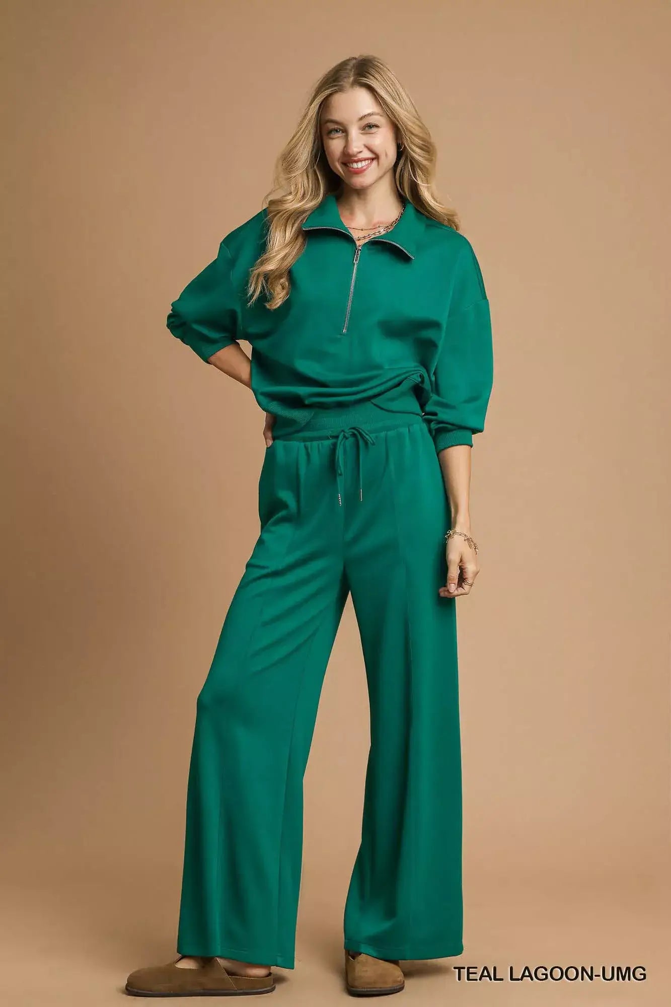 Umgee Half Zip Drop Shoulder Sweatshirt in teal lagoon color, styled with matching pants.