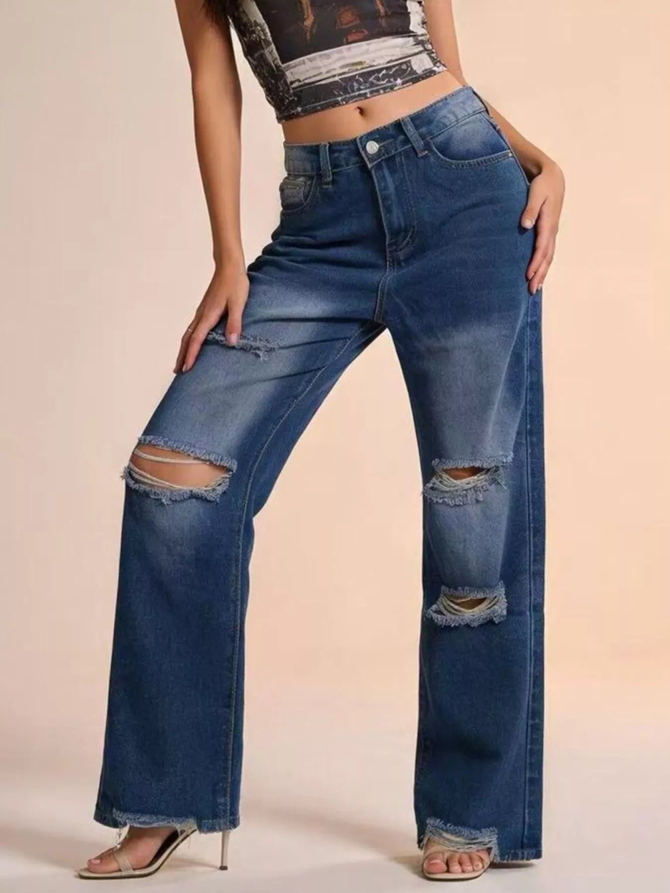 Distressed Wide Leg Jeans with buttoned pockets and ripped design, showcasing a stylish fit and casual look.