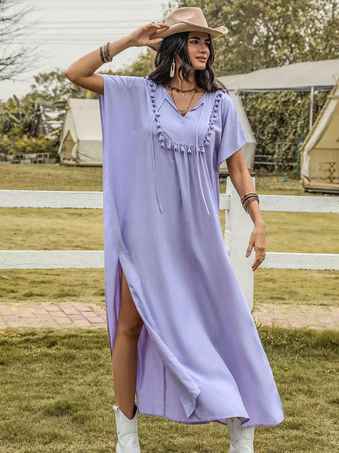 Model wearing a Side Slit Tie Neck Flutter Sleeve Dress in lavender with side slit, perfect for elegant occasions.