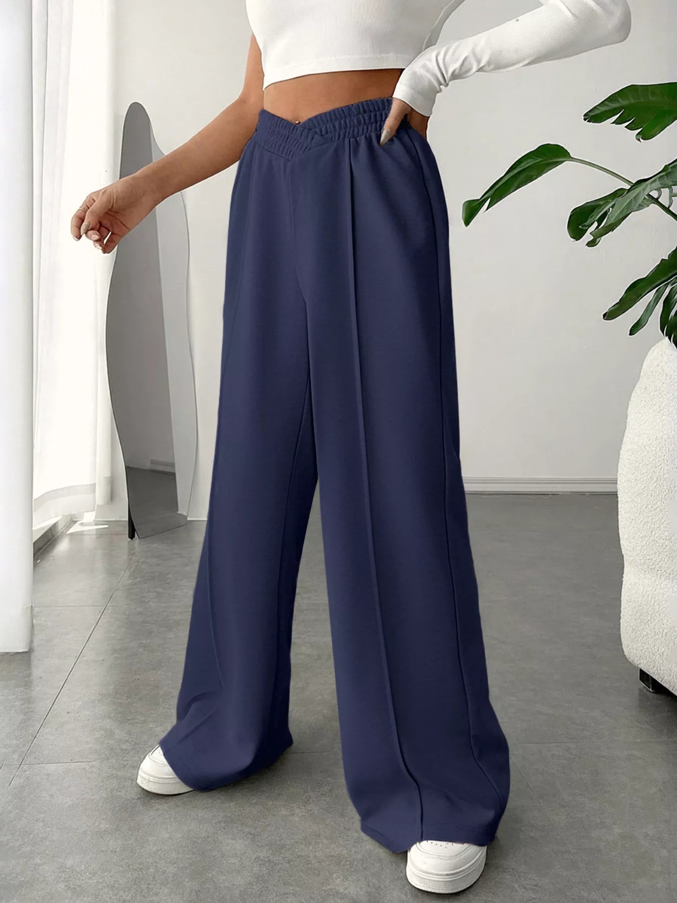 Wide Leg High Waist Pants in navy, styled with a cropped top, showcasing elegant everyday style in a modern setting.