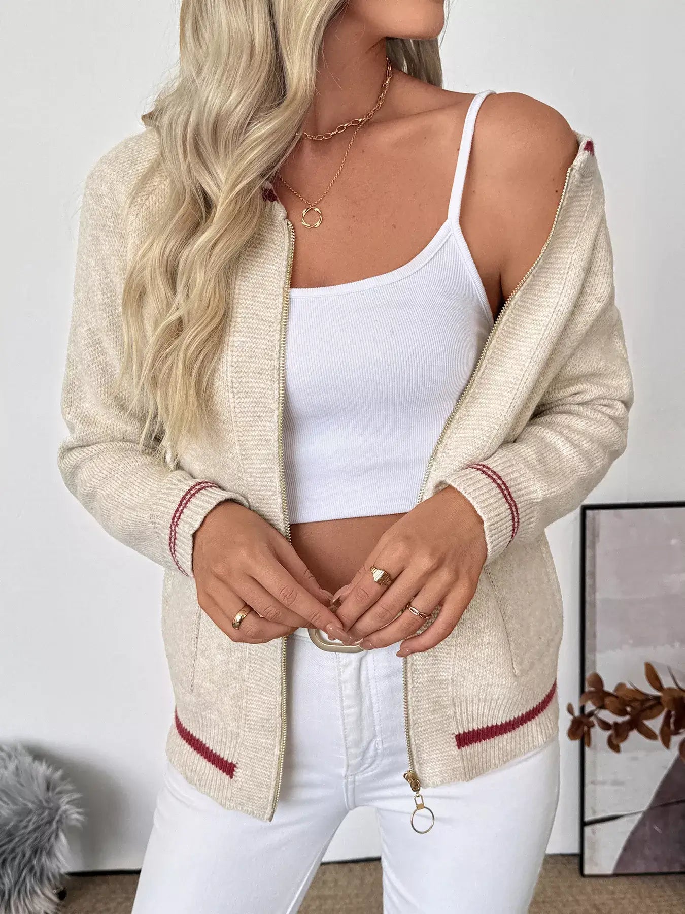 Model wearing a Zip Up Contrast Trim Cardigan with Button Detail over a white tank top.