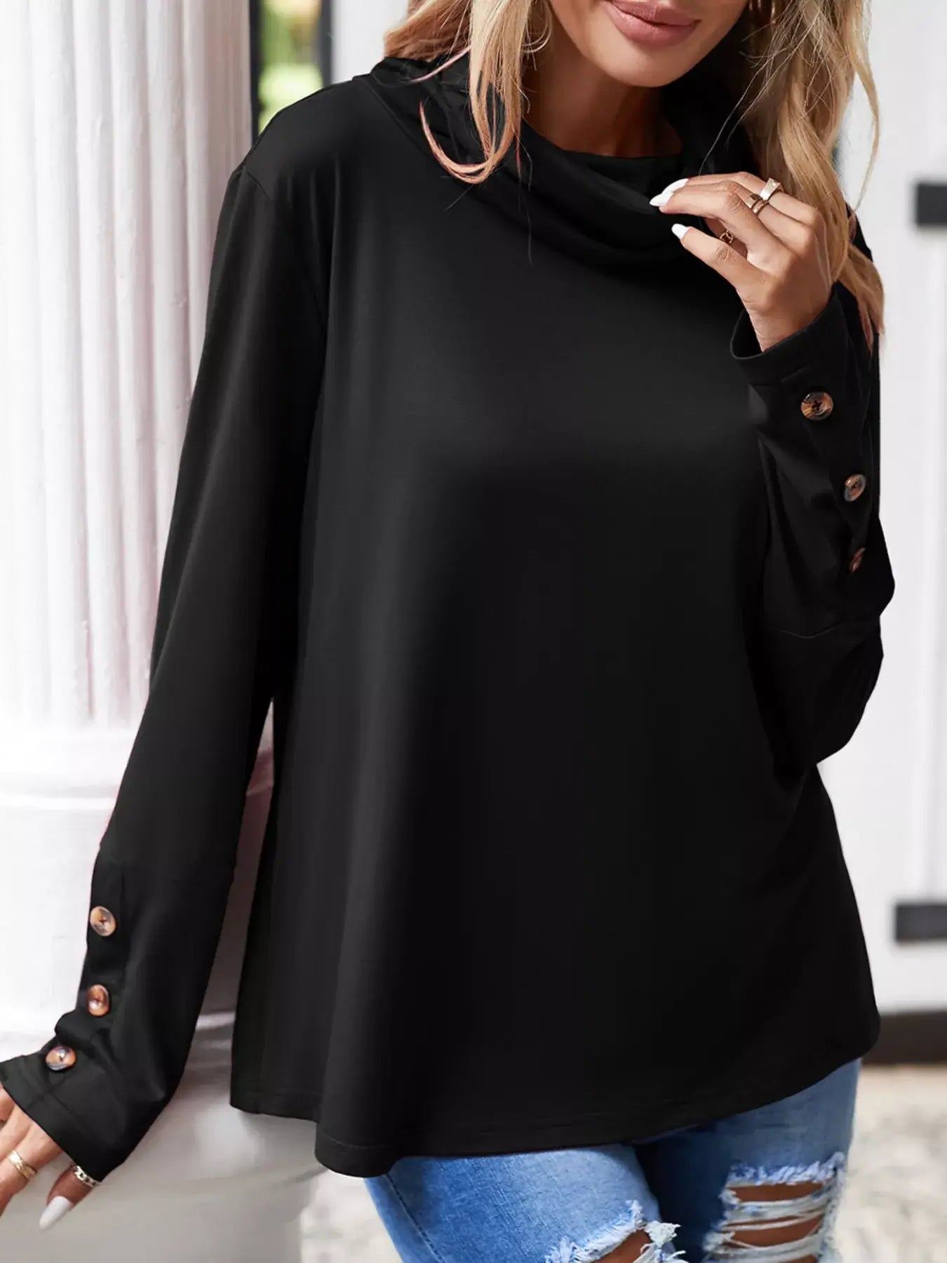 Cowl neck long sleeve blouse in black with button details, featuring a relaxed fit and elegant draped neckline.