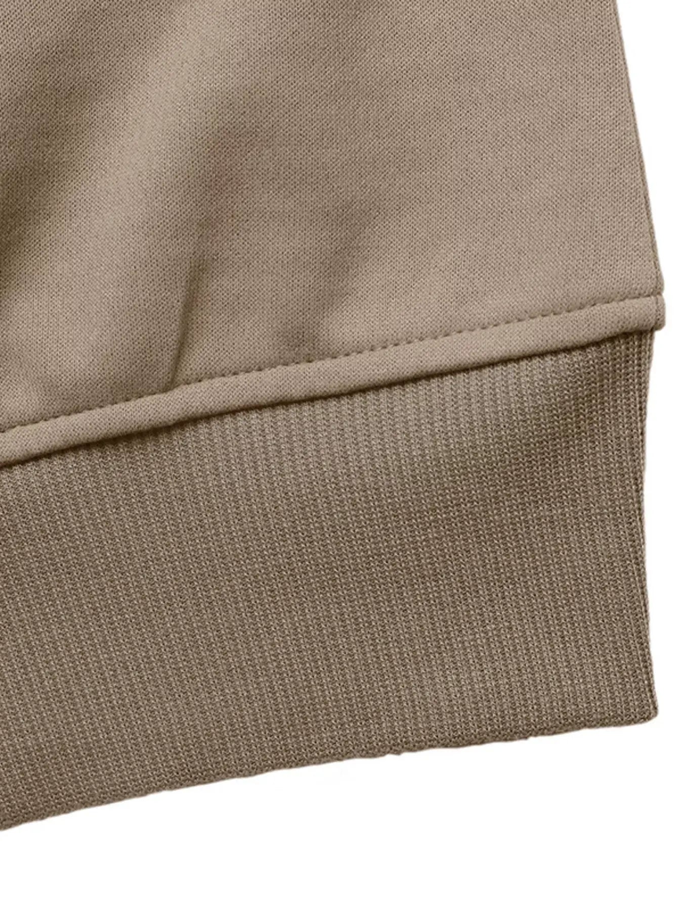 Detail of the hem and cuff of the Zip Up Raglan Sleeve Jacket, showcasing its comfortable fit and quality fabric.
