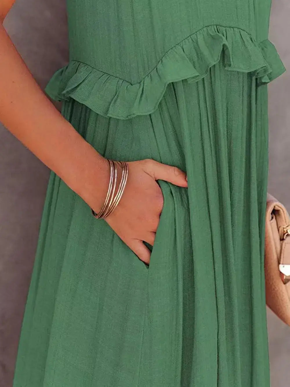 Close-up of Ruffled Sleeveless Tiered Maxi Dress with Pockets showcasing ruffle detail and hidden pocket.