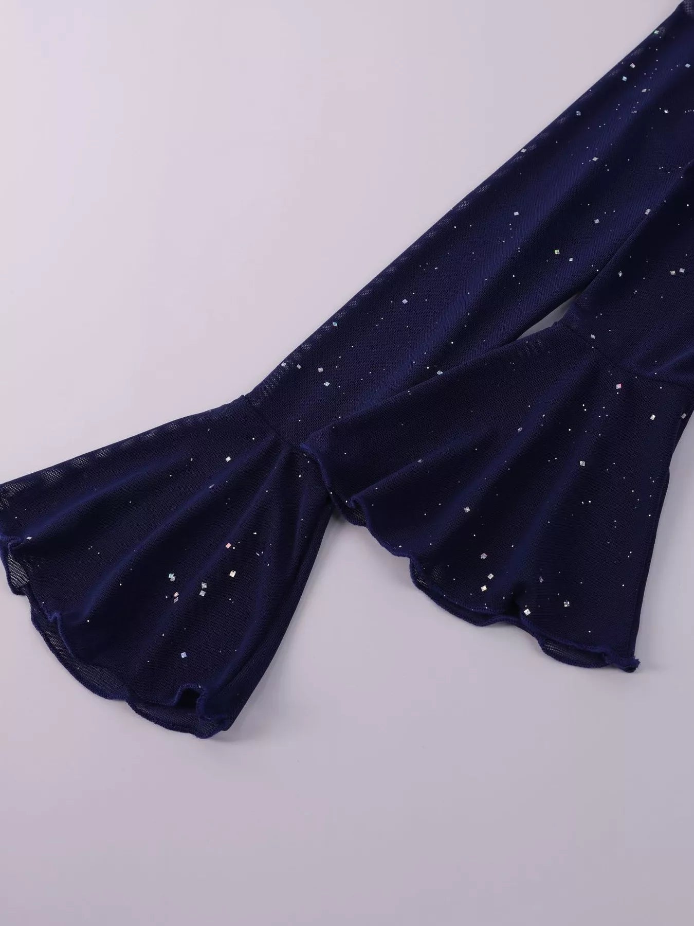 Glitter Off-Shoulder Maxi Dress fabric detail featuring flared sleeves with glitter accents on a dark background.