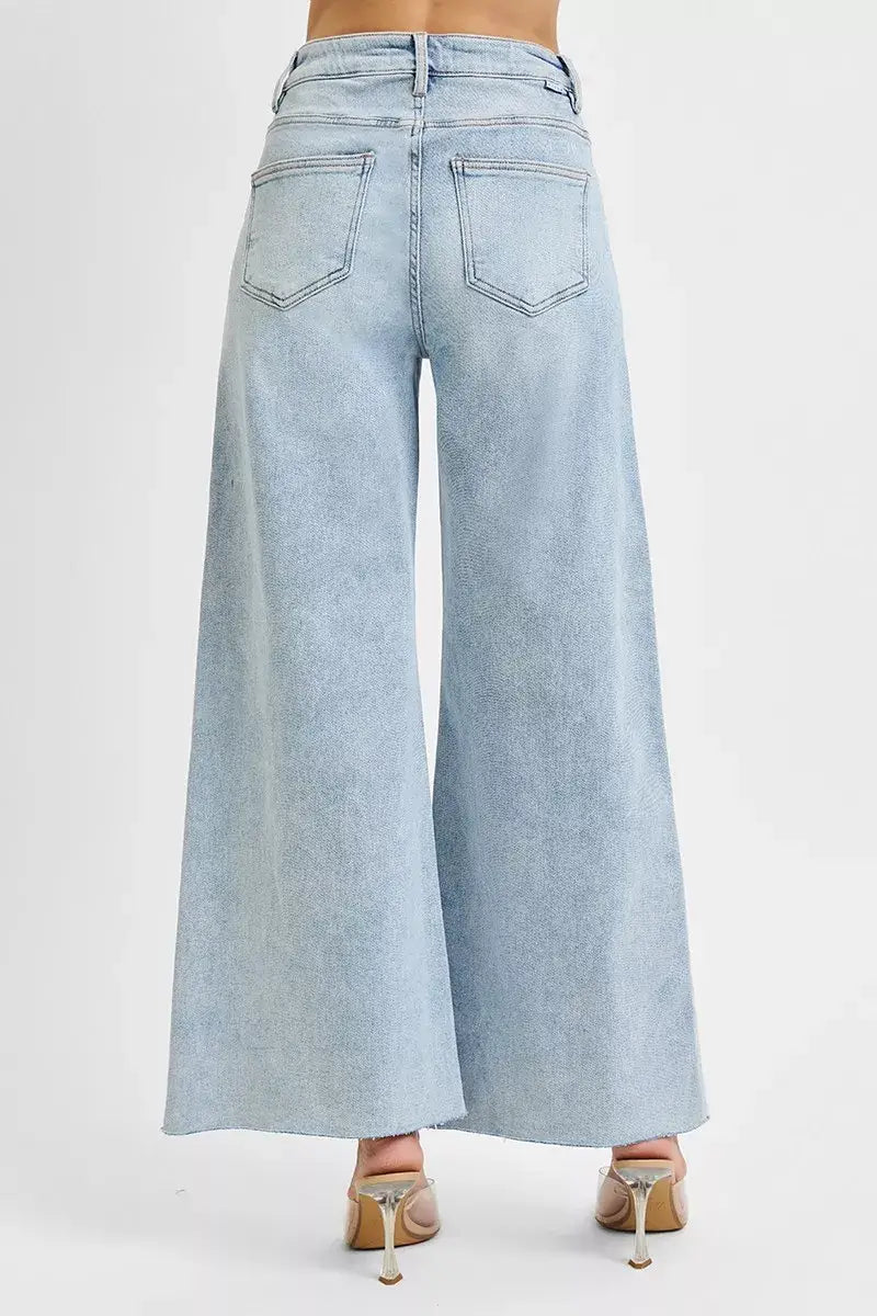 Back view of RISEN Full Size High Rise Ankle Wide Palazzo Jeans in light wash, showcasing wide leg style and flattering fit.