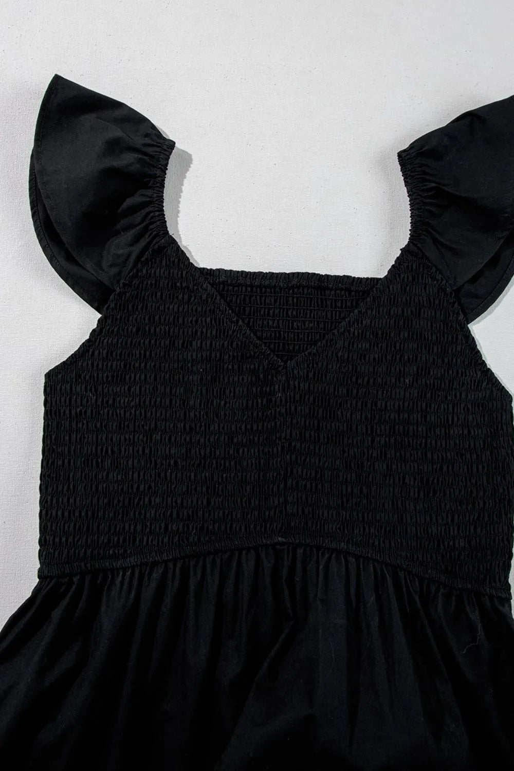 V Neck Ruffled Cap Sleeve Smocked Maxi Dress showing ruffled cap sleeves and smocked bodice in black.