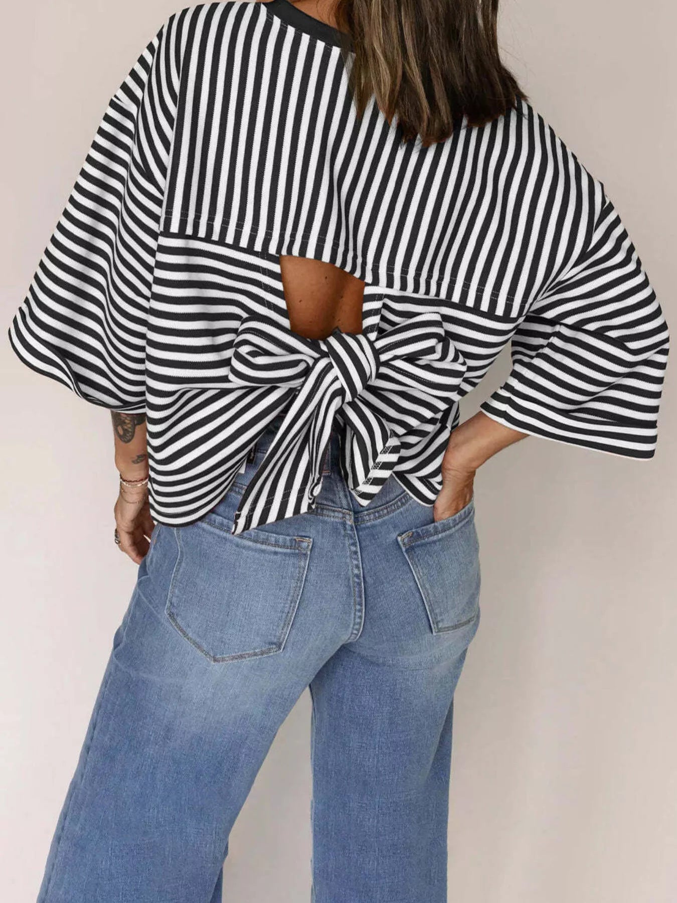 Striped Back Bow Tie T-Shirt showcasing the oversized design and stylish back bow detail.