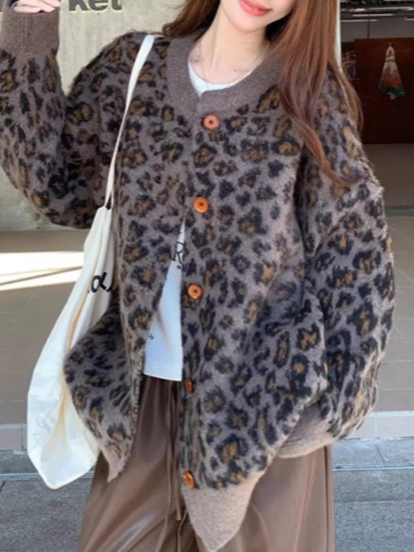 Leopard Button Up Cardigan showcased on a model, featuring a bold leopard print and buttoned design for casual layering.