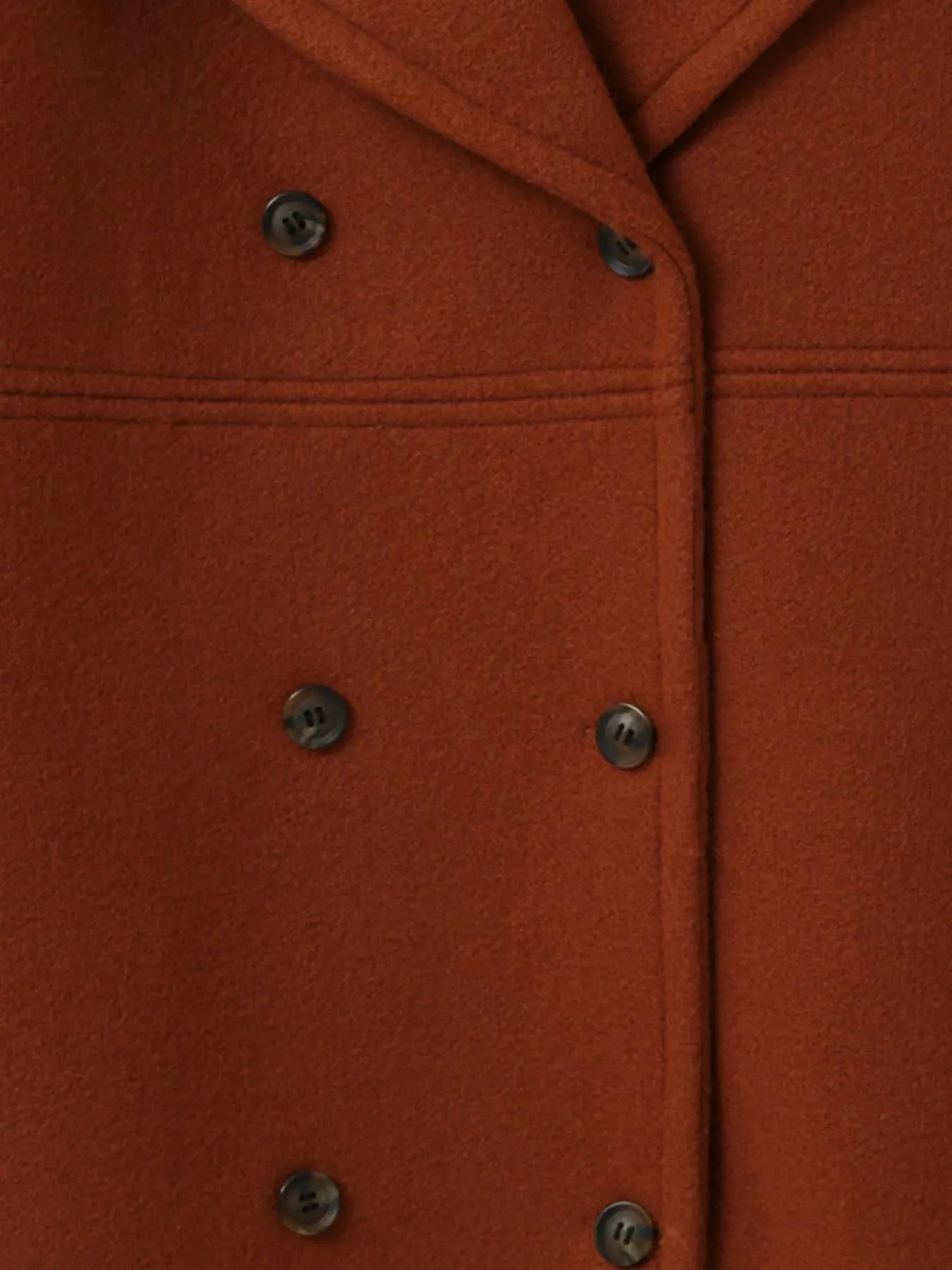 Double-Breasted Long Sleeve Coat in warm orange fabric featuring button detail and structured design.