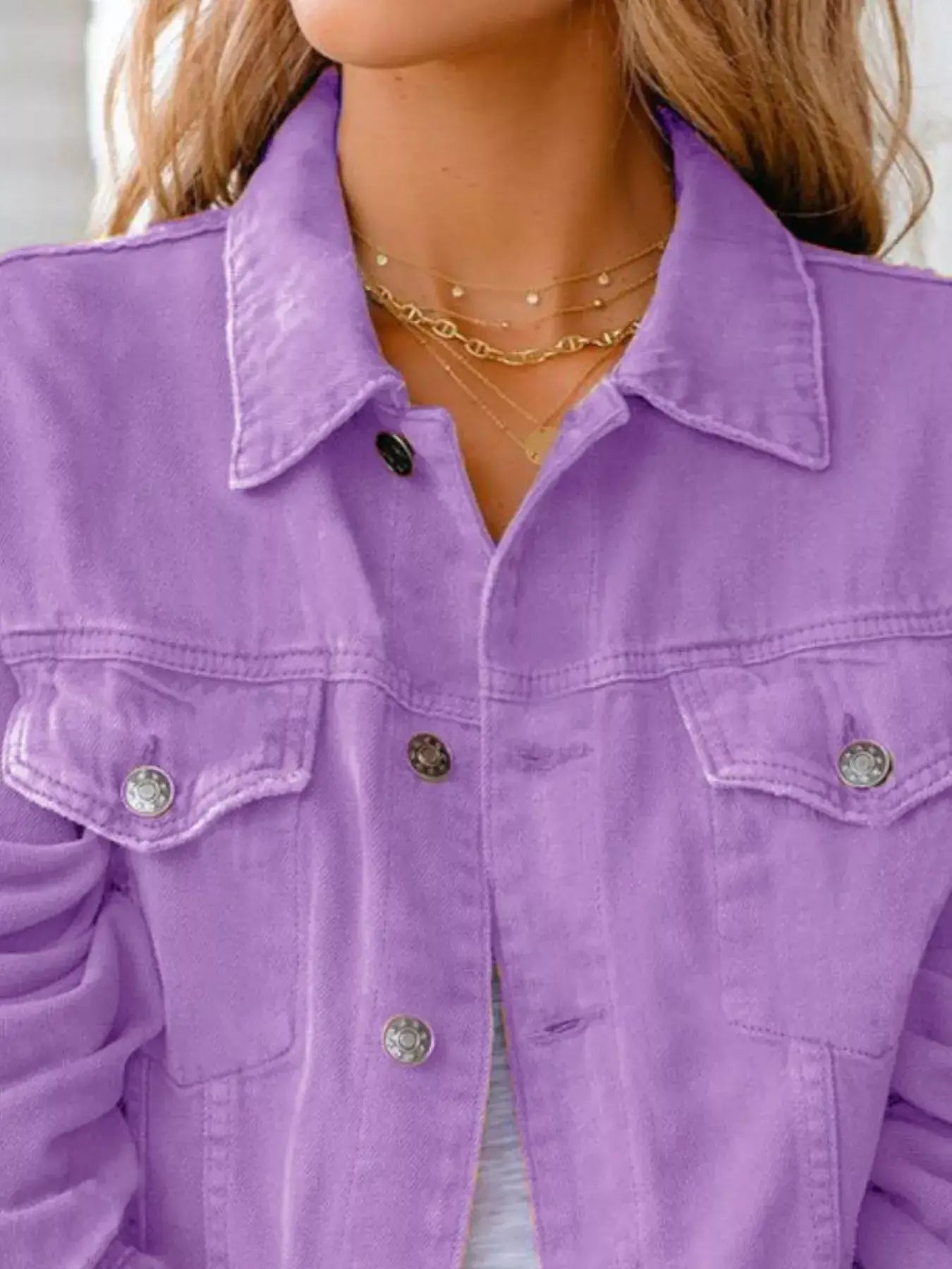 Lavender button-up long sleeve denim jacket for women with silver buttons and layered necklaces.