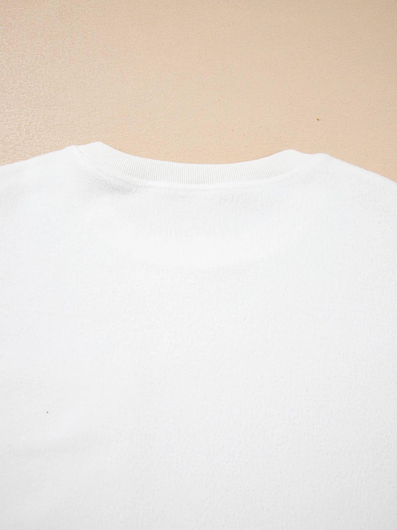 Back view of the Exposed Seam Chest Pocket Knit Pullover Sweatshirt in white, showcasing its soft fabric and crew neck design.