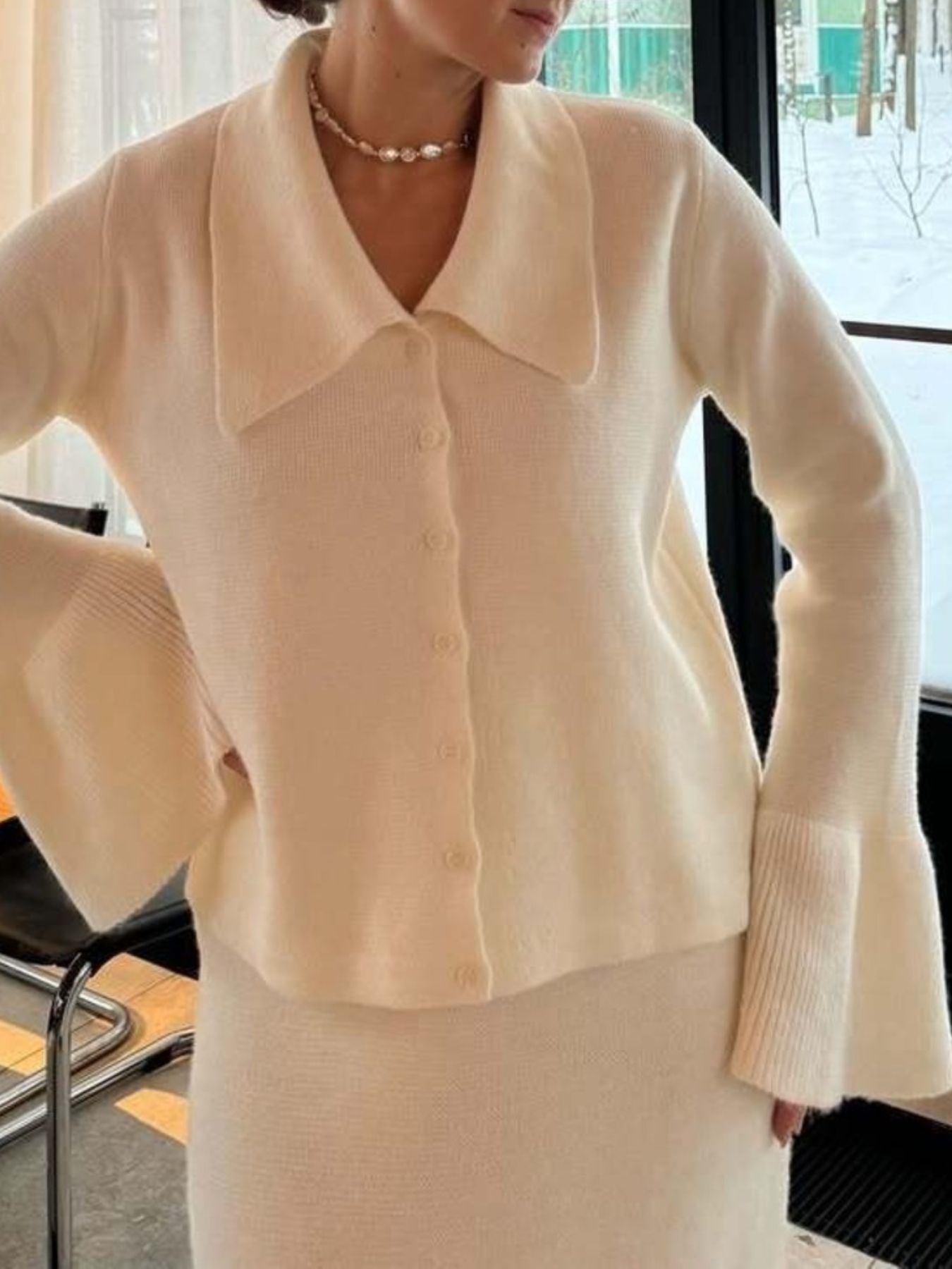 Model wearing a Button Down Cardigan and Skirt Knit Set in cream color, featuring ribbed details and bell sleeves.