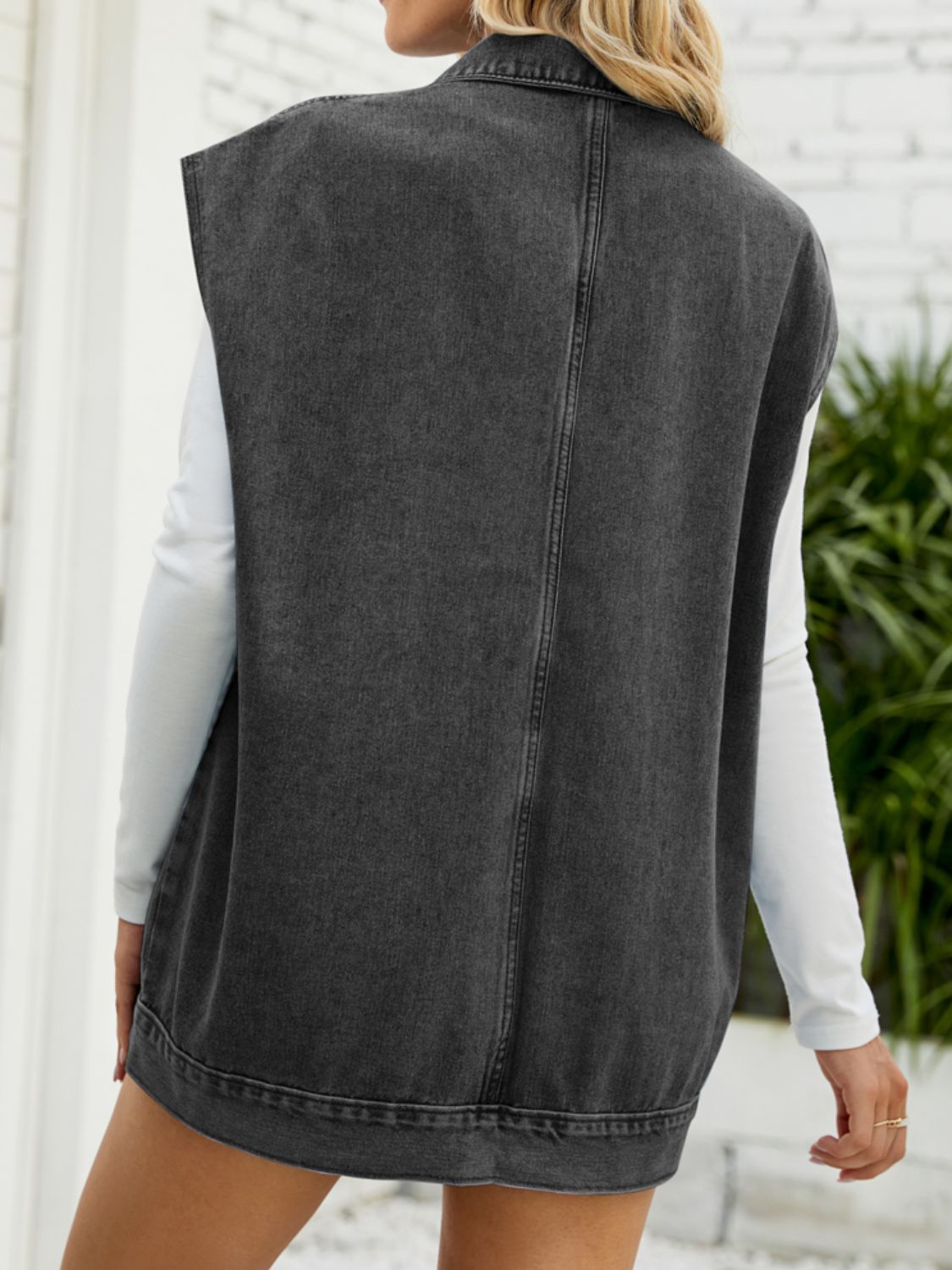 Collared Neck Sleeveless Denim Top with Pockets, view from the back, casual style, soft gray denim with white shirt underneath.