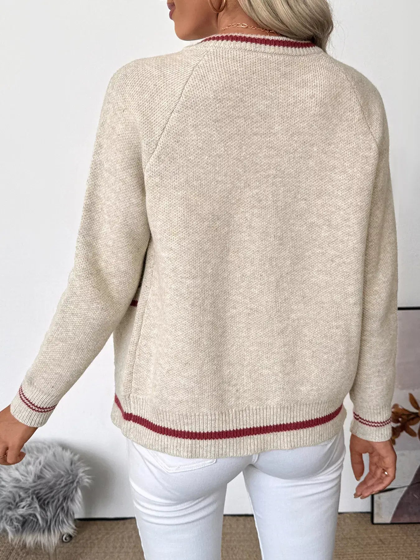Back view of a woman wearing a Zip Up Contrast Trim Cardigan with button detail and stylish contrast trim.