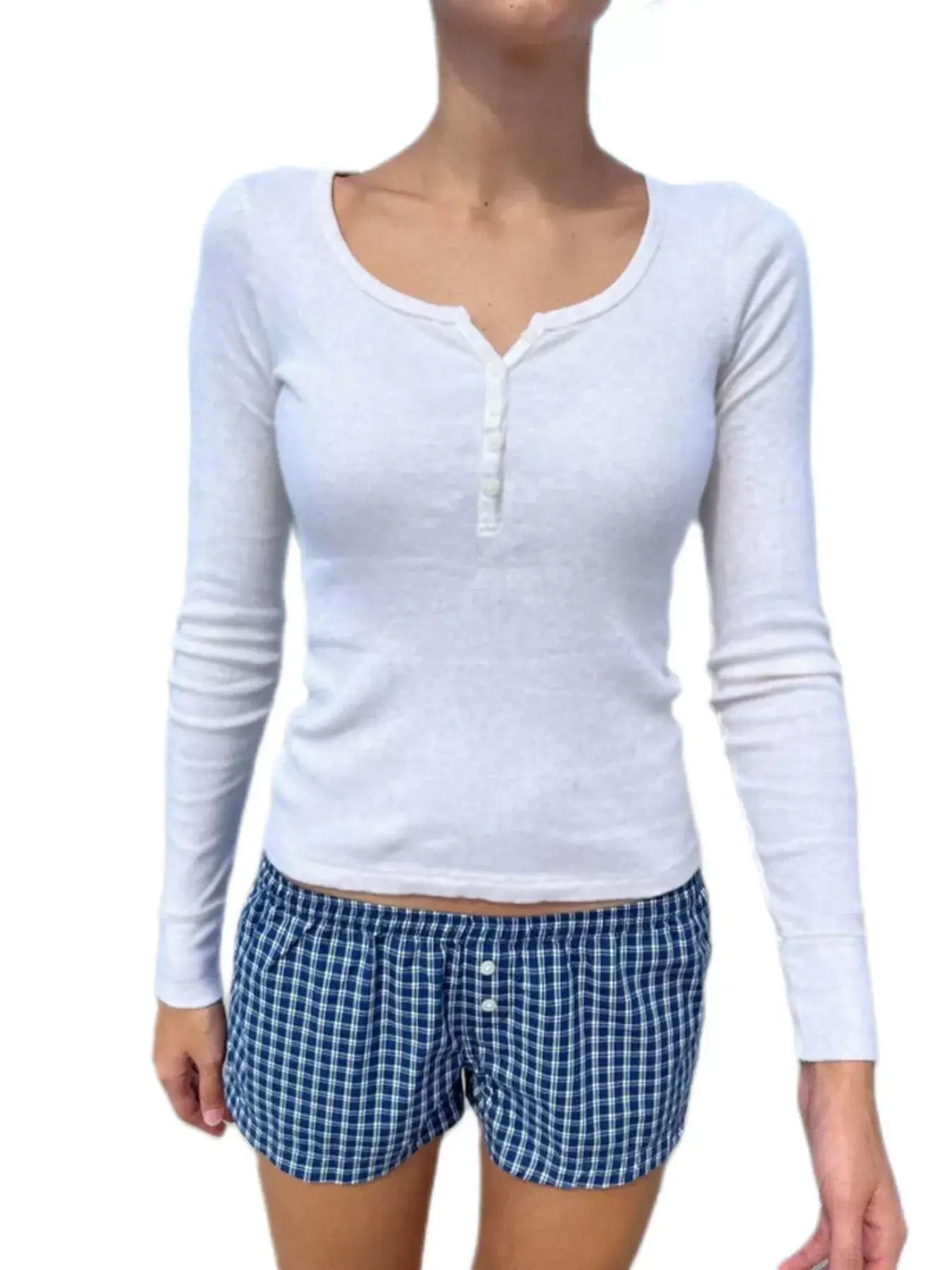 Model wearing a white long sleeve Henley t-shirt paired with blue checkered shorts.