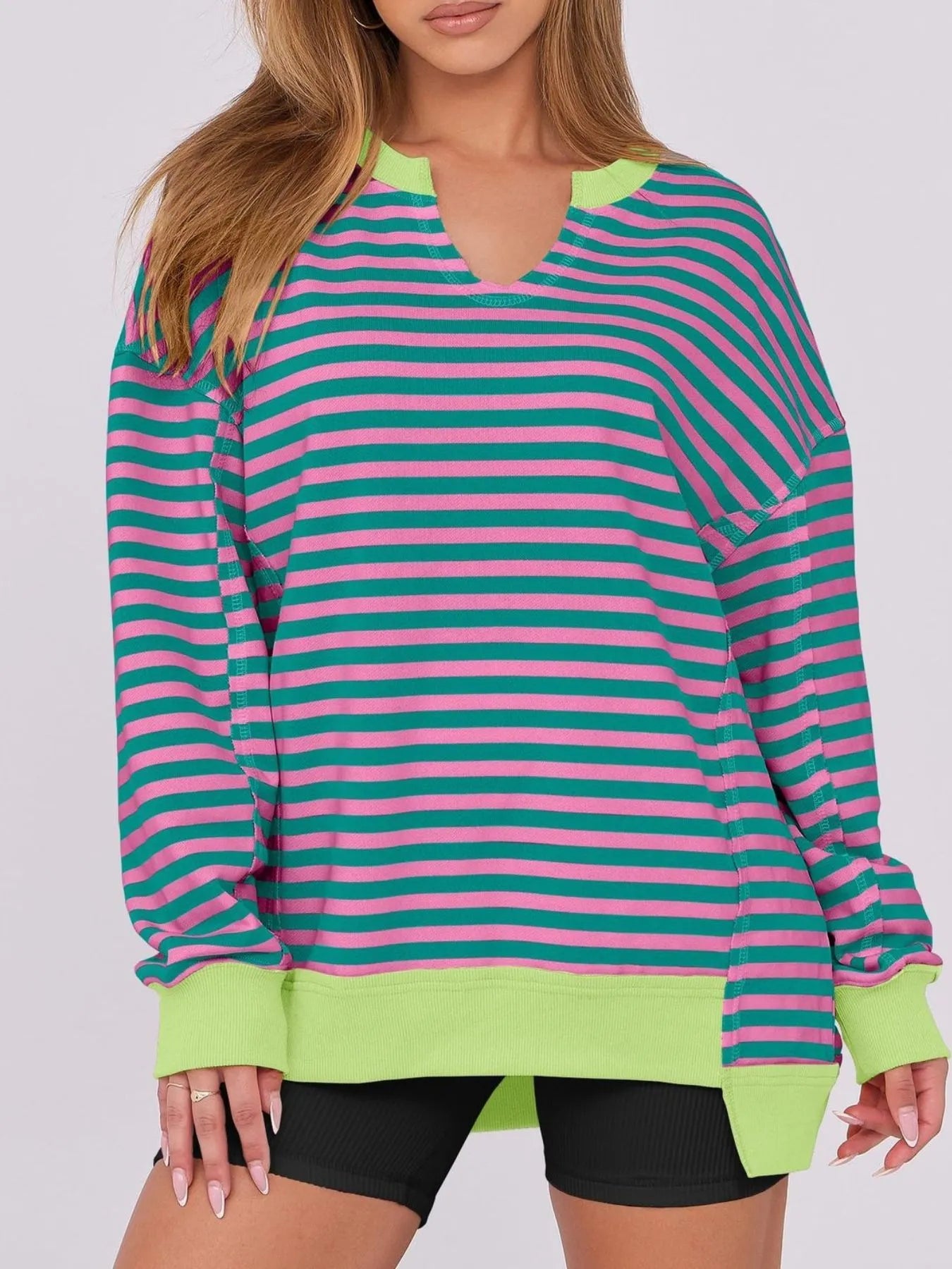 Notched Long Sleeve Oversized Sweatshirt in vibrant stripes, featuring contrast stitching and a relaxed fit.